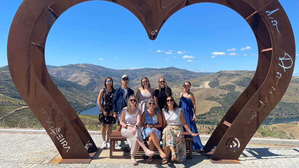 Sommelier pouring Douro wines in a small group on a Douro Valley wine tour from Porto with two family wineries, Portugal