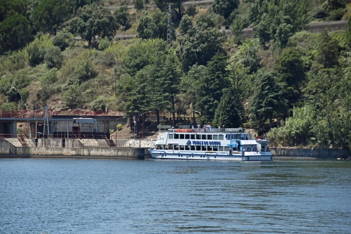 Tour boat entering the Carrapatelo dam on a two wineries cruise Douro Valley wine tour from Porto