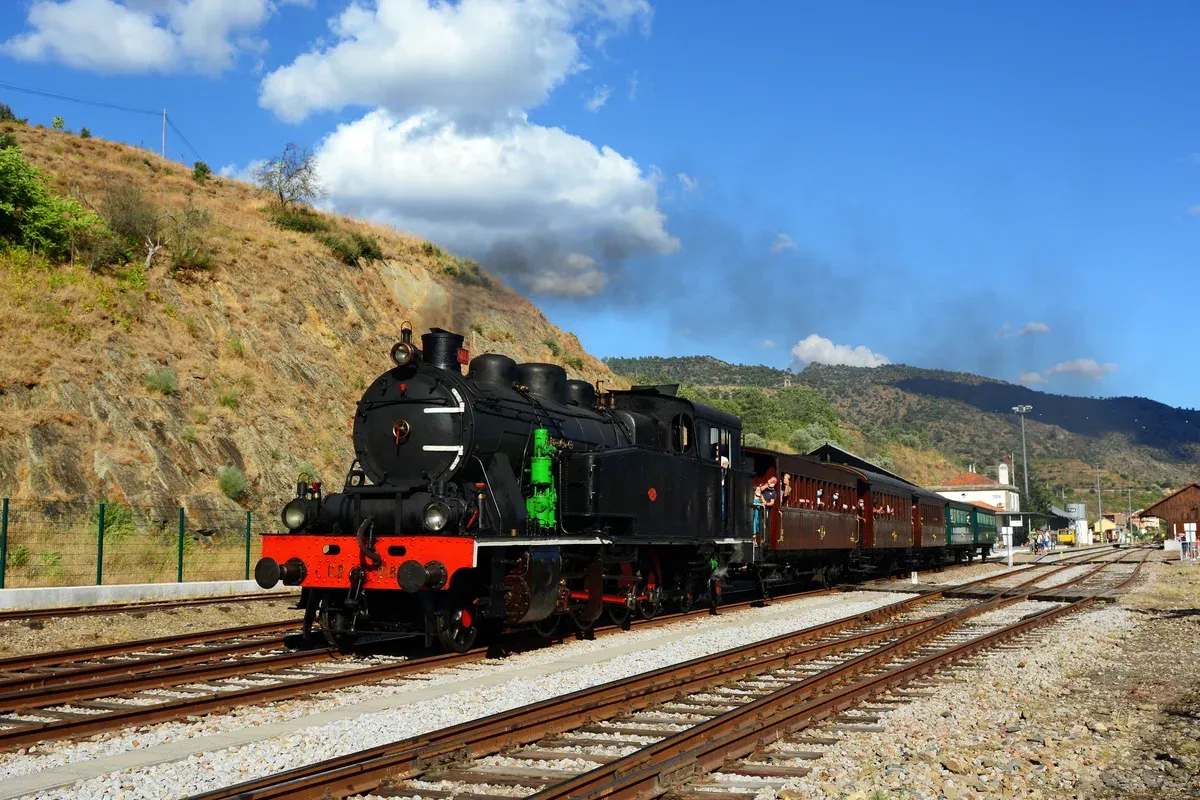 Historic steam train at Tua station on a boat and train lunch Douro Valley wine tour from Porto